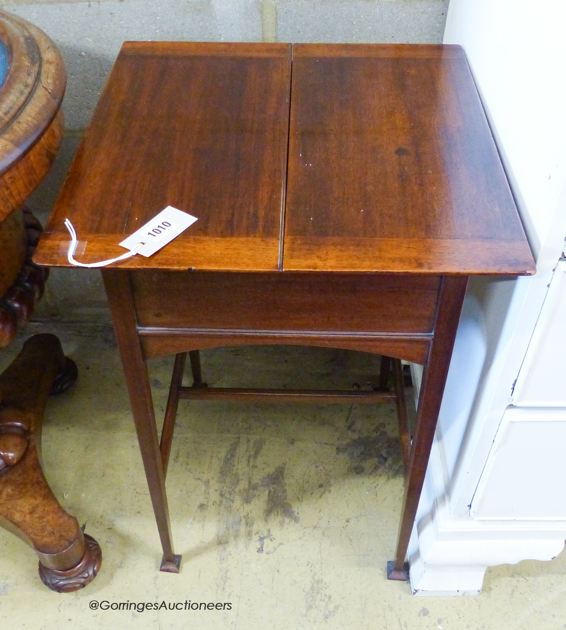 An Edwardian mahogany work table, with twin hinged flap top, W.44cm D.44cm H.69cm